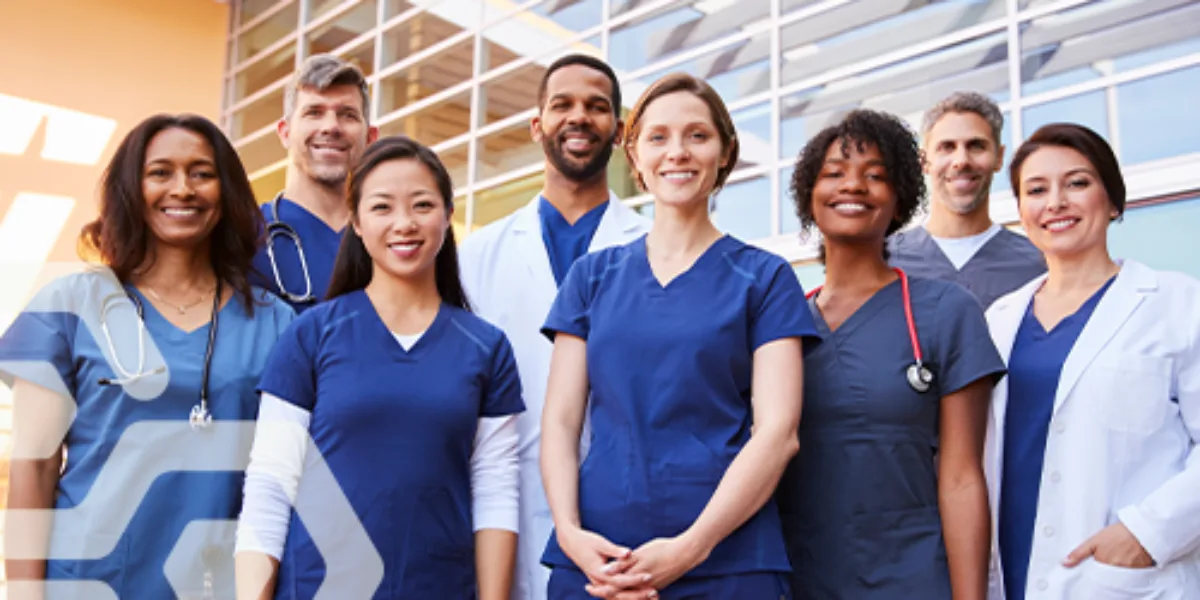 group of healthcare professionals of varying demographics wearing scrubs and doctors coats