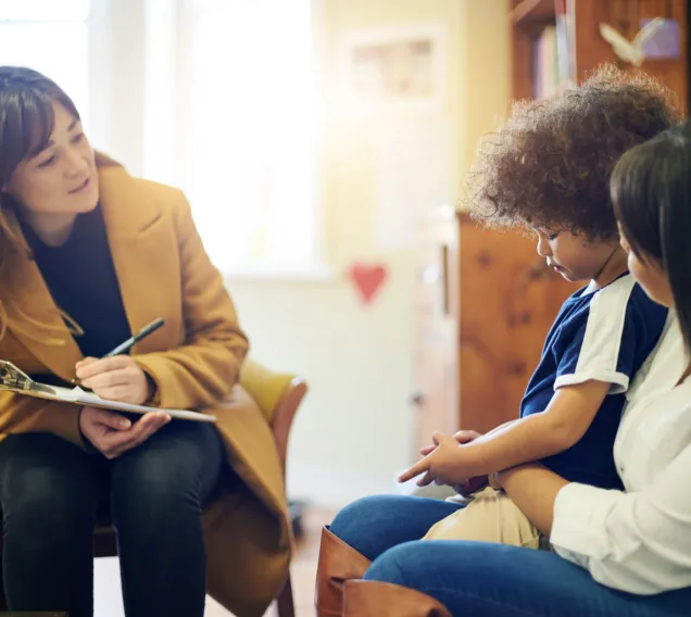 Mother, sad child and psychologist consultation in office for depression, anxiety or mental health. Psychology doctor, therapist or mama with boy for counselling, therapy or talking for healthcare